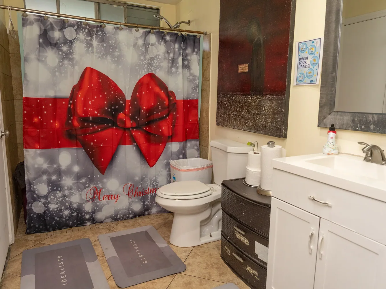 Accessible bathroom with white fixtures and vanity.