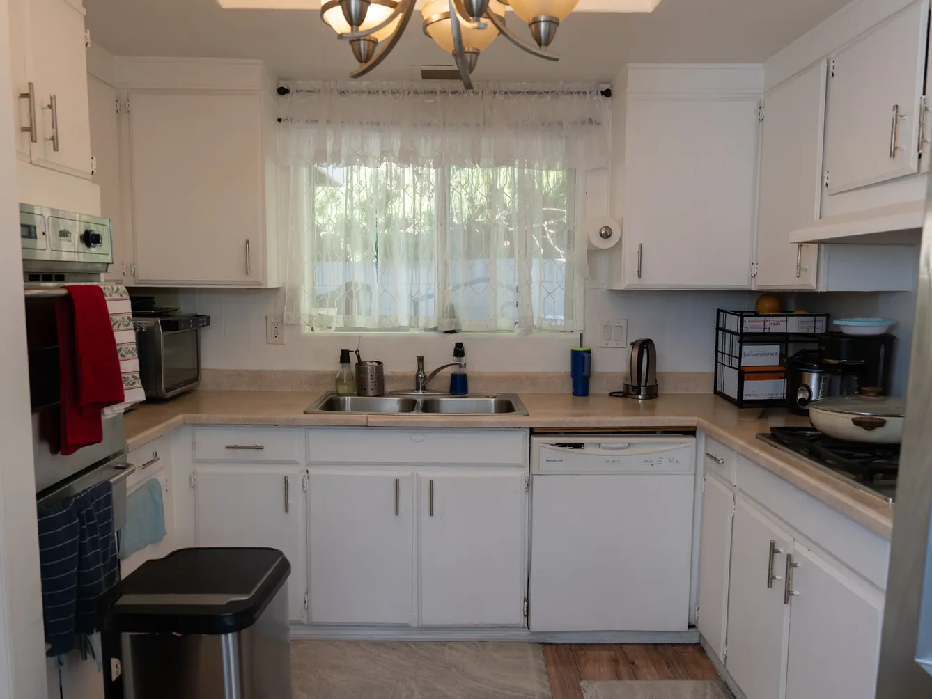 Bright accessible kitchen with white cabinets.